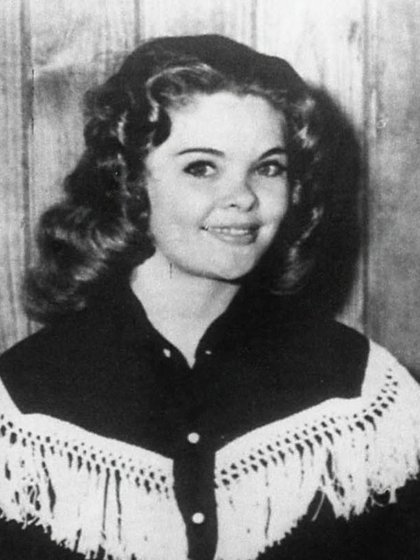 Close portrait of Candy Barr from the 1960 wire photograph, holding drumsticks.